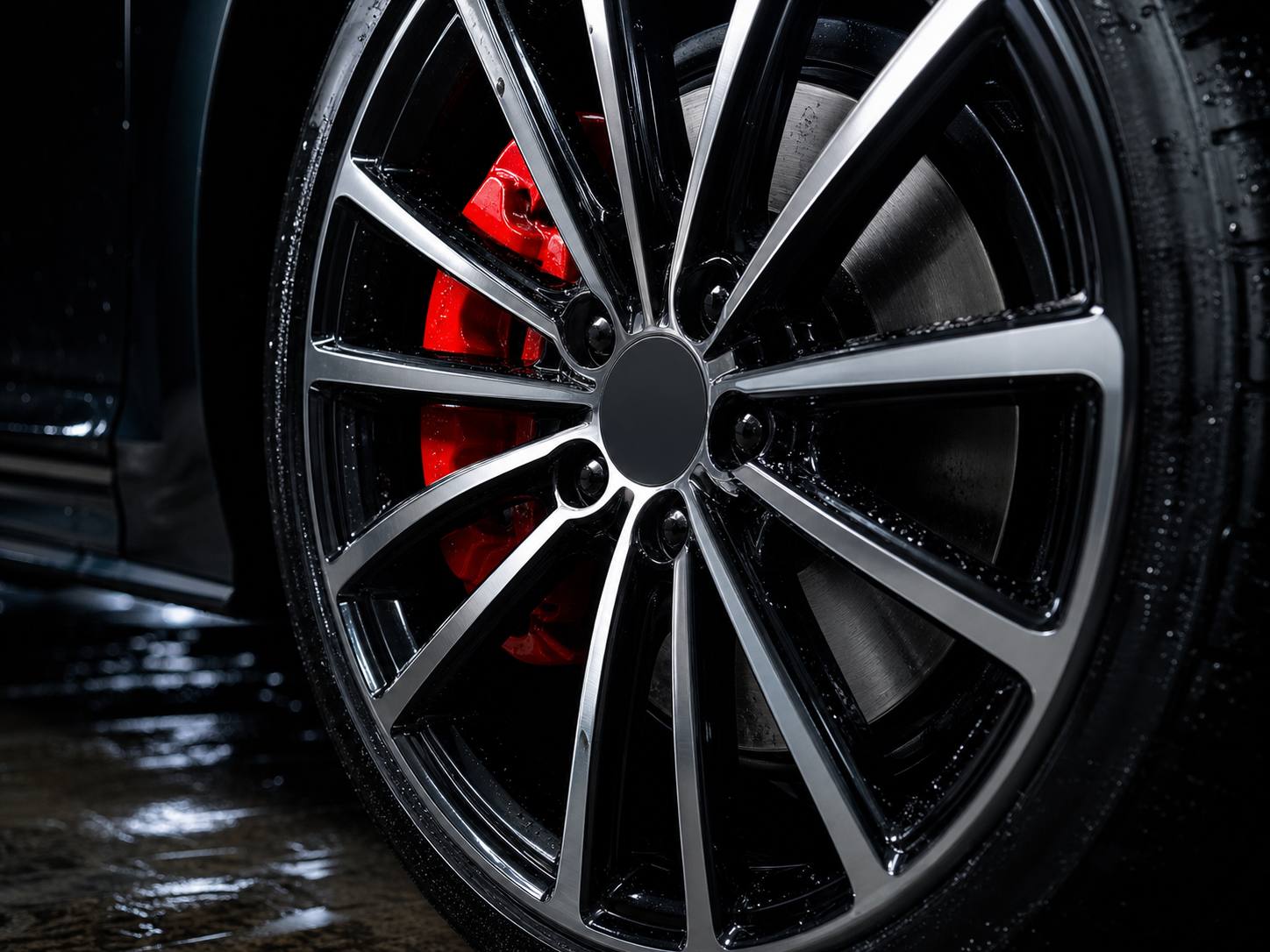 A polished alloy wheel and red caliper after a deep clean